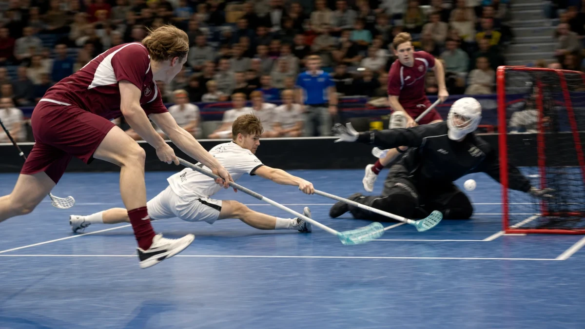Spelare skjuter från slottet medan målvakten kastar sig över krysset